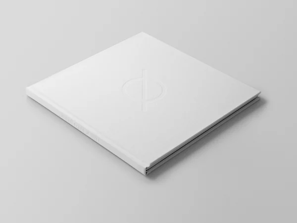 The white edition of the Ø art book, closed and viewed at an angle.