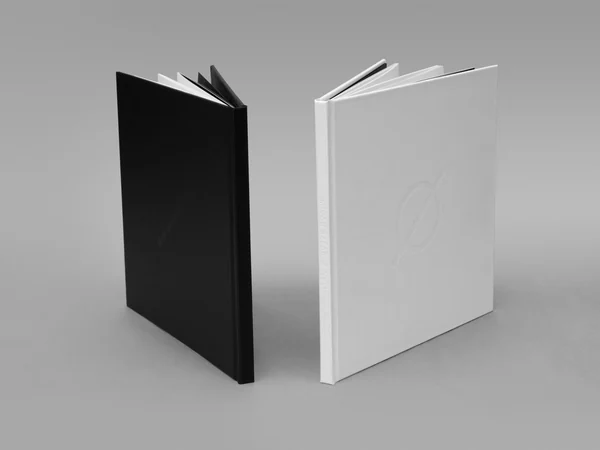 Black and white editions of the Ø art book standing open side by side.