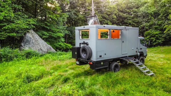 The Hi-Fi Tea House truck parked in a green woodland clearing.